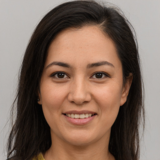 Joyful latino young-adult female with long  brown hair and brown eyes