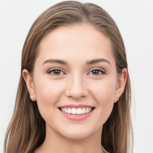 Joyful white young-adult female with long  brown hair and grey eyes