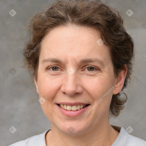 Joyful white adult female with short  brown hair and grey eyes