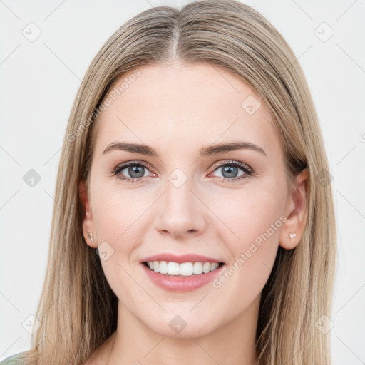 Joyful white young-adult female with long  brown hair and green eyes