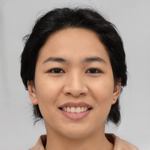Joyful asian young-adult female with medium  black hair and brown eyes