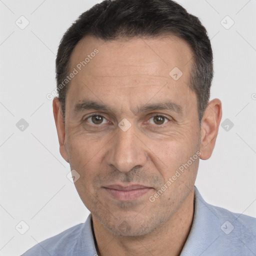 Joyful white adult male with short  black hair and brown eyes