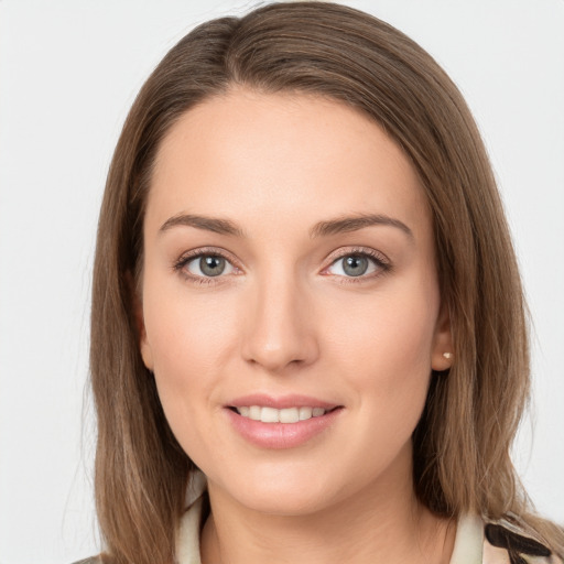 Joyful white young-adult female with long  brown hair and grey eyes