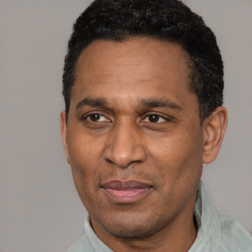 Joyful latino adult male with short  black hair and brown eyes