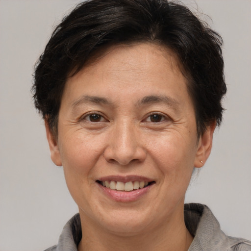 Joyful white adult female with short  brown hair and brown eyes