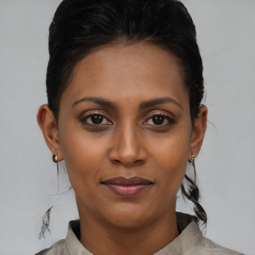 Joyful black young-adult female with short  brown hair and brown eyes