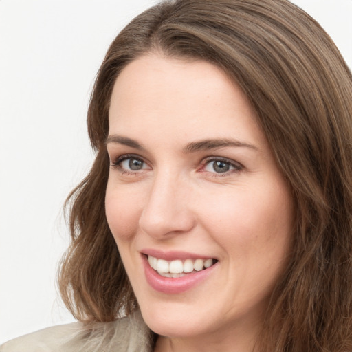 Joyful white young-adult female with medium  brown hair and green eyes