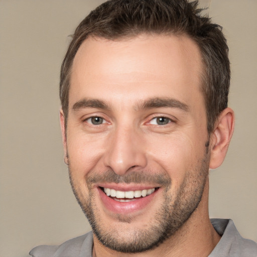 Joyful white young-adult male with short  brown hair and brown eyes