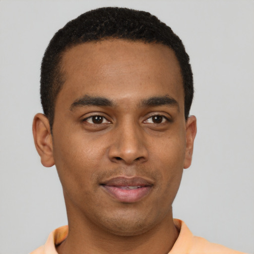 Joyful black young-adult male with short  black hair and brown eyes