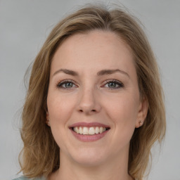 Joyful white young-adult female with medium  brown hair and blue eyes