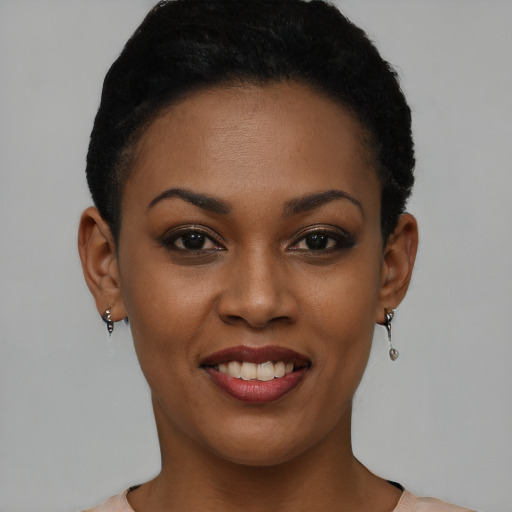 Joyful black young-adult female with short  brown hair and brown eyes