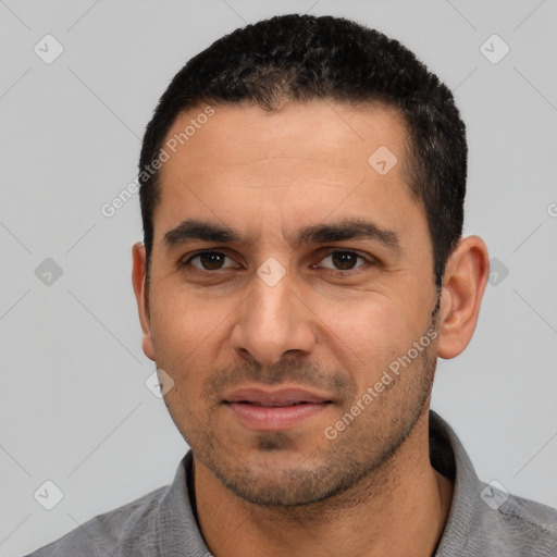 Joyful white adult male with short  black hair and brown eyes