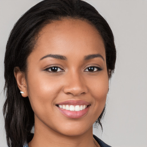 Joyful latino young-adult female with long  black hair and brown eyes