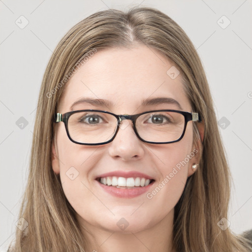 Joyful white young-adult female with long  brown hair and green eyes