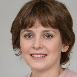 Joyful white young-adult female with medium  brown hair and blue eyes