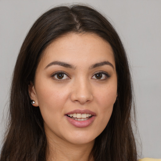 Joyful white young-adult female with long  brown hair and brown eyes