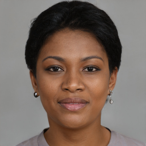 Joyful black young-adult female with short  black hair and brown eyes