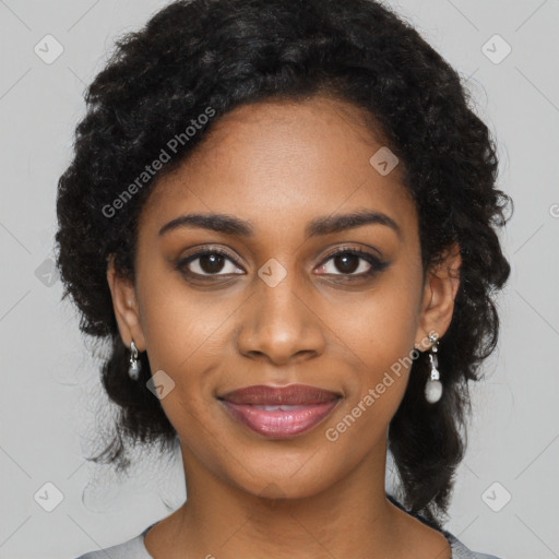 Joyful black young-adult female with long  black hair and brown eyes