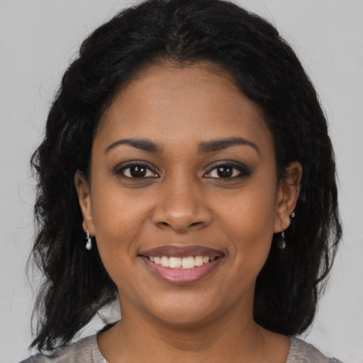 Joyful black young-adult female with medium  black hair and brown eyes