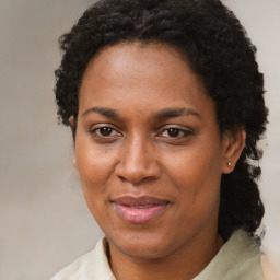 Joyful black adult female with short  brown hair and brown eyes