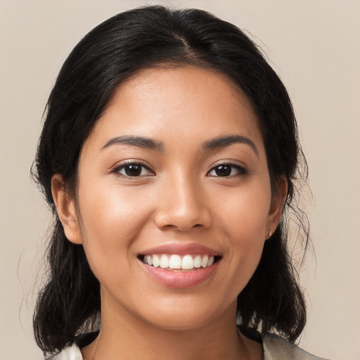 Joyful latino young-adult female with medium  black hair and brown eyes