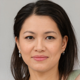 Joyful white adult female with medium  brown hair and brown eyes