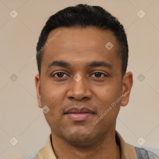 Joyful latino young-adult male with short  black hair and brown eyes