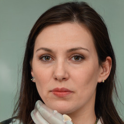 Joyful white adult female with long  brown hair and brown eyes