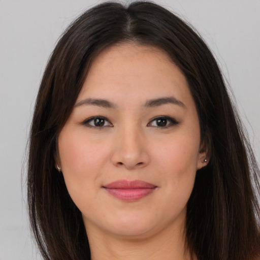 Joyful asian young-adult female with long  brown hair and brown eyes
