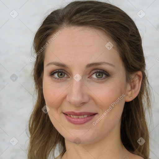 Joyful white adult female with long  brown hair and green eyes