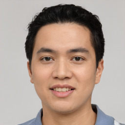 Joyful asian young-adult male with short  black hair and brown eyes