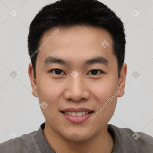 Joyful asian young-adult male with short  black hair and brown eyes