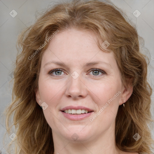 Joyful white adult female with medium  brown hair and blue eyes