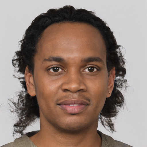 Joyful black young-adult male with short  black hair and brown eyes