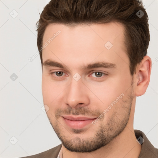 Joyful white young-adult male with short  brown hair and brown eyes