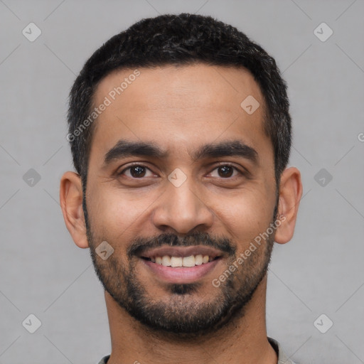 Joyful latino young-adult male with short  black hair and brown eyes