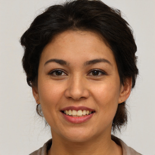 Joyful white adult female with medium  brown hair and brown eyes