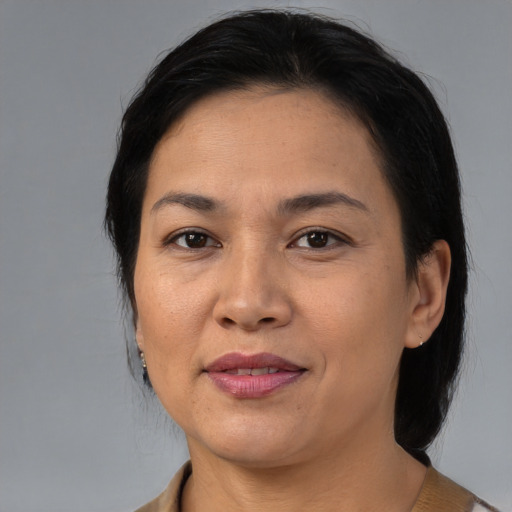 Joyful asian adult female with medium  brown hair and brown eyes