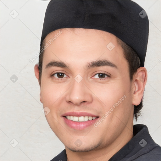 Joyful white young-adult male with short  black hair and brown eyes