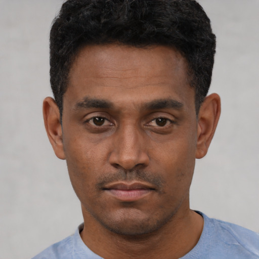 Neutral black young-adult male with short  black hair and brown eyes