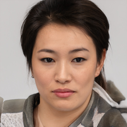 Joyful asian young-adult female with medium  brown hair and brown eyes