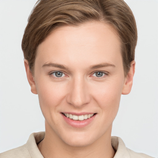 Joyful white young-adult female with short  brown hair and grey eyes