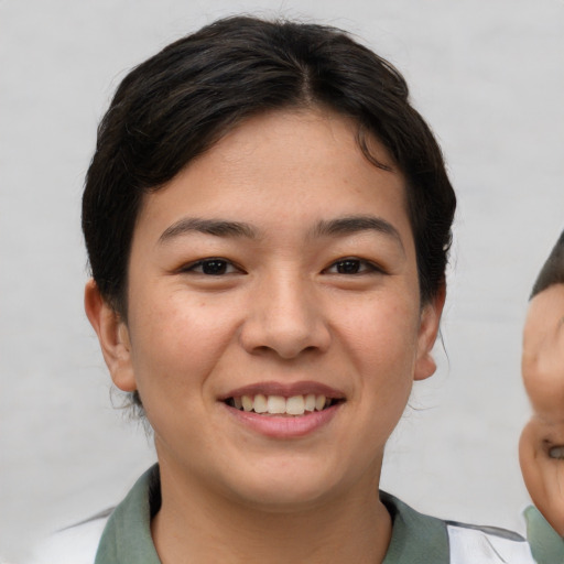 Joyful asian young-adult female with short  brown hair and brown eyes