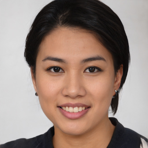Joyful asian young-adult female with medium  black hair and brown eyes