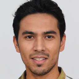 Joyful asian young-adult male with short  black hair and brown eyes