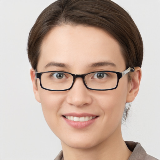 Joyful white young-adult female with short  brown hair and grey eyes