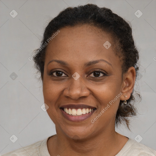 Joyful black adult female with short  brown hair and brown eyes