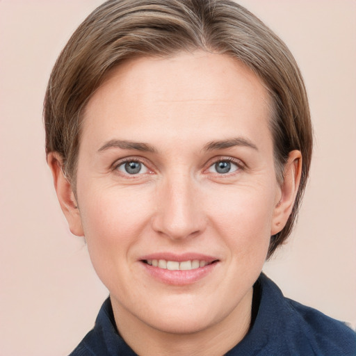 Joyful white adult female with medium  brown hair and grey eyes