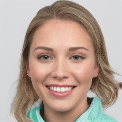 Joyful white young-adult female with medium  brown hair and green eyes