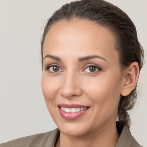 Joyful white young-adult female with medium  brown hair and brown eyes